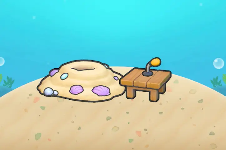 A pile of sand next to a table with a small microphone on it in Pokopia