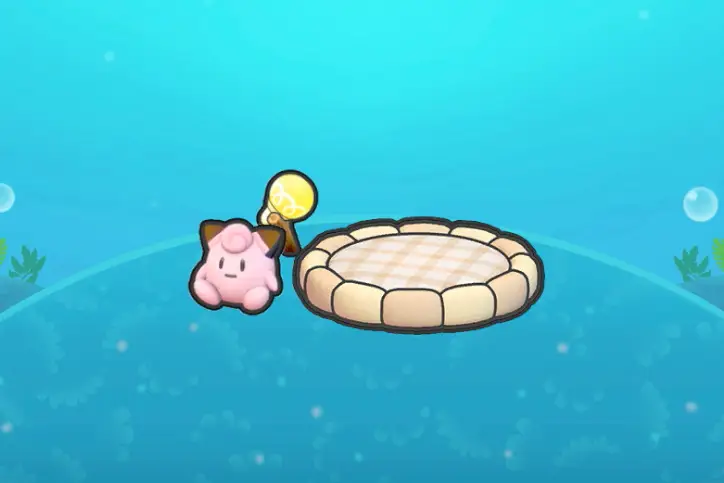 A round bed near a light with a Clefairy doll in Pokopia