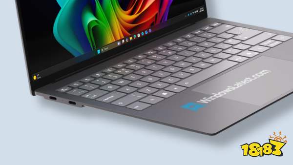 A laptop displaying the Windows 11 taskbar with visible apps and a 'WindowsLatest.com' label on the surface.
