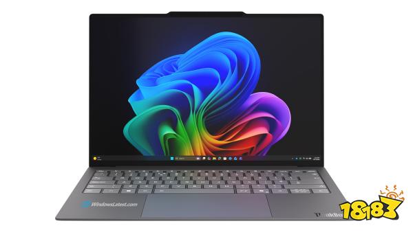 A Lenovo ThinkBook laptop displays a colorful Windows 11 wallpaper with 'WindowsLatest.com' on the keyboard palm rest.