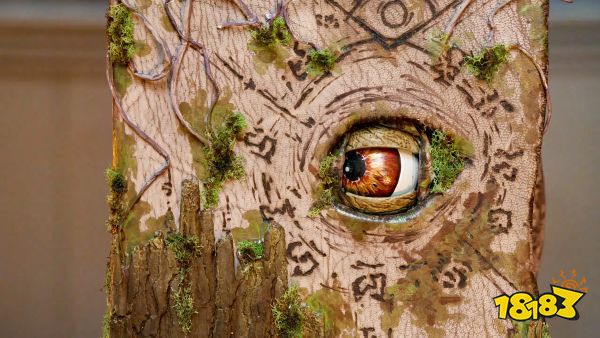 An image of a gnarled, wooden spellbook with an animatronic eye featured in Tales From Woodcreek.