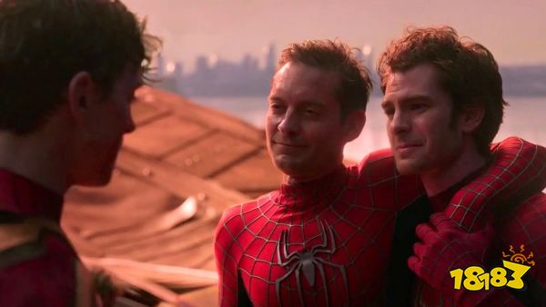 Spider-Mans Tobey Maguire and Andrew Garfield, both looking battered and dirty, support each other and smile at fellow Spider-Man Tom Holland in Spider-Man: No Way Home