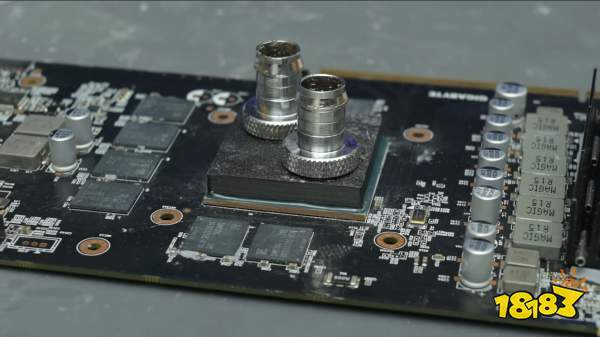 A Gigabyte graphics card is displayed with exposed Samsung memory chips and a custom liquid cooling block installed on the GPU.