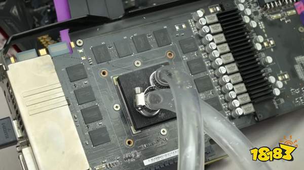 A disassembled GPU with visible circuitry and cooling pipes attached to the core area.