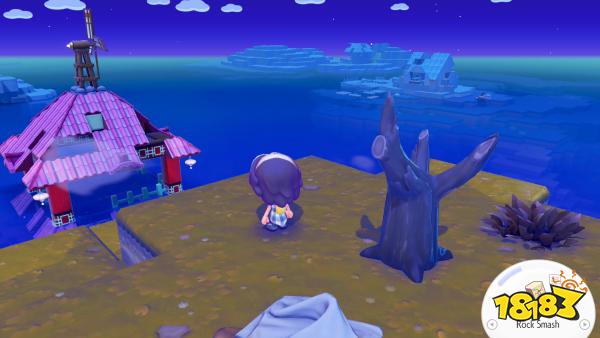 A character in 'Fae Farm' stands on a cliff overlooking a pink-roofed house with a windmill by the sea, with a prompt in the corner showing the 'Rock Smash' action.