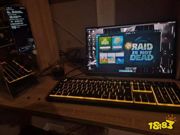 An Arzopa monitor displays a desktop screen featuring the game launcher with the text 'RAID IS NOT DEAD', next to a glowing yellow keyboard on a desk setup.