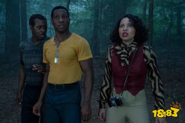 Lovecraft Country’s Courtney B. Vance, Jonathan Majors, and Jurnee Smollett stand in a forest at night, looking with concern at something offscreen.