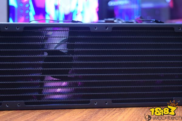 A close-up of an unbranded computer radiator with illuminated RGB colors in the background.