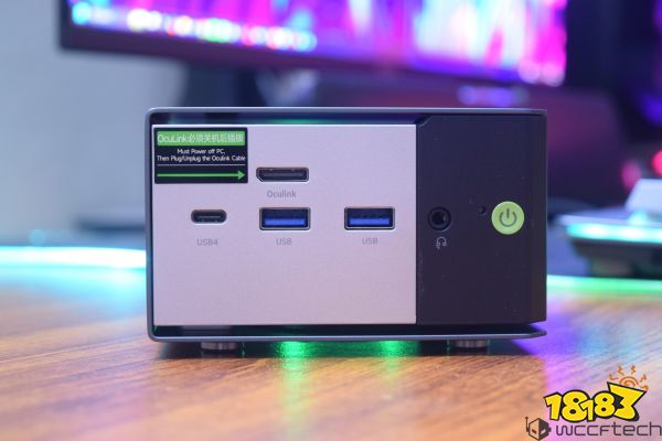 A compact PC with a front panel featuring two USB ports, one USB4 port, an Oculink port, a headphone jack, and a power button, with a label stating