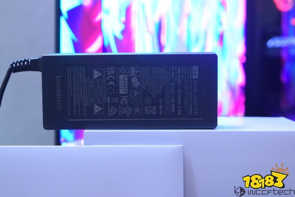 A close-up of a GVE AC/DC adapter with model number GM122, showing specifications like